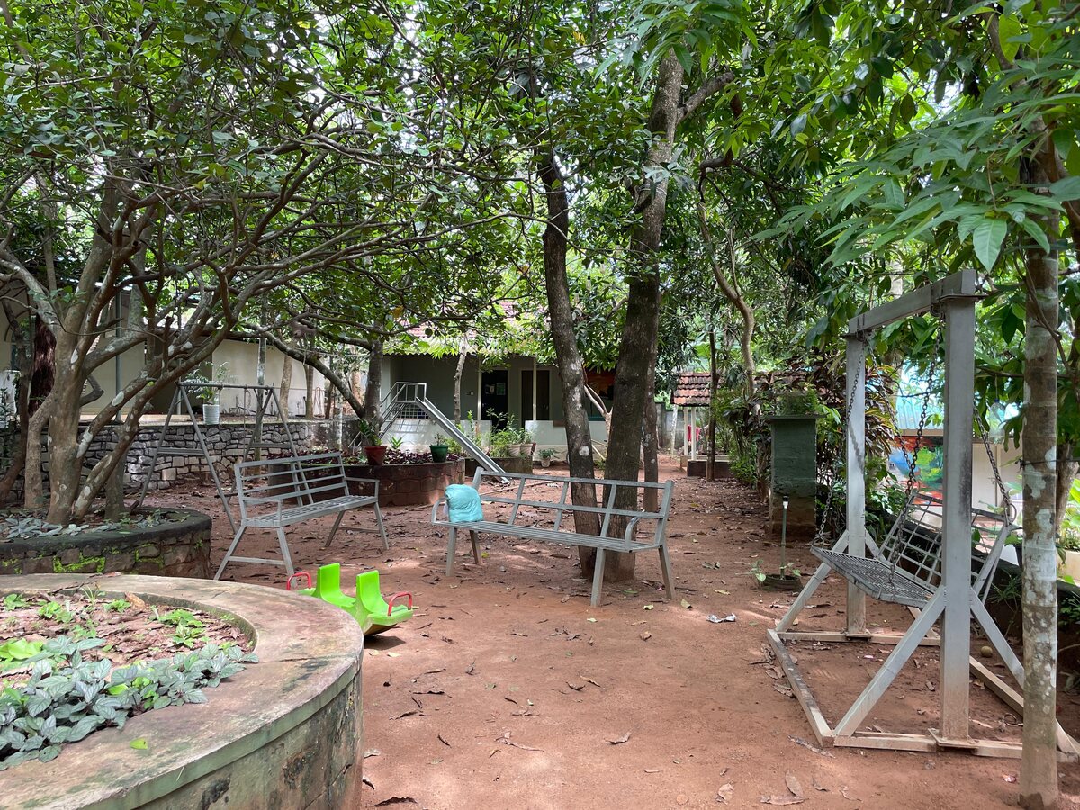 Quiet seating nook shaded by trees on the Punarjjany campus